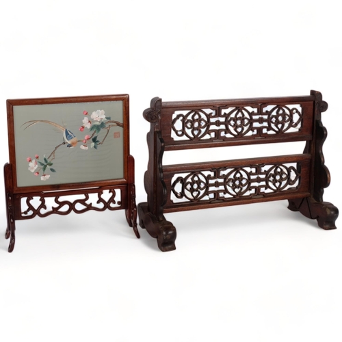 536 - An Oriental hardwood carved and pierced table-top screen, 44cm across, and a double-sided silk embro... 