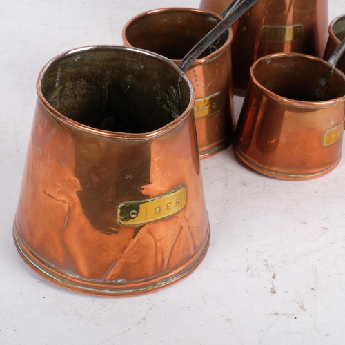 550 - 2 similar graduated sets of copper cider measures, with brass plaques