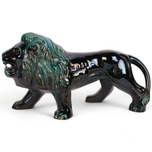 560 - A Canadian Blue Mountain pottery lion sculpture, L39cm, small chip on front foot