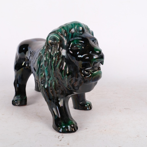 560 - A Canadian Blue Mountain pottery lion sculpture, L39cm, small chip on front foot