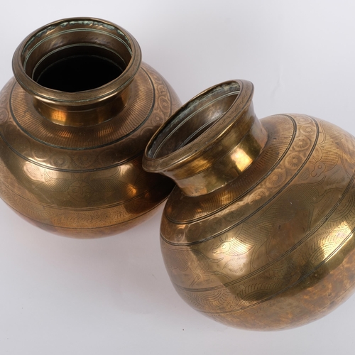 596 - A pair of 19th century Indian heavy gauge brass vases, with engraved animals and geometric bands, he... 