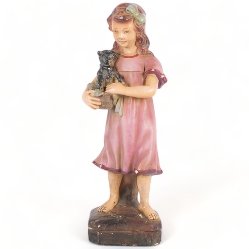 608 - A Vintage plaster figure of a girl with a dog in a basket, stamped to the rear 