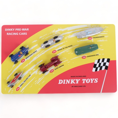 638 - A Dinky Toys table-top display, Dinky pre-war racing cars, mounted on wooden backboard, with various... 