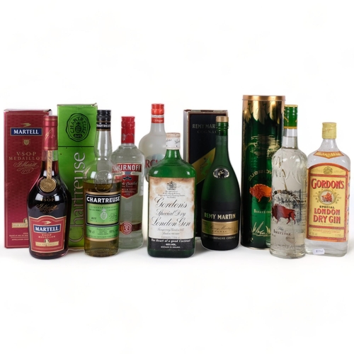 675 - Various bottles of spirits, including Remy Martin, and Martell Cognac