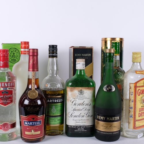 675 - Various bottles of spirits, including Remy Martin, and Martell Cognac