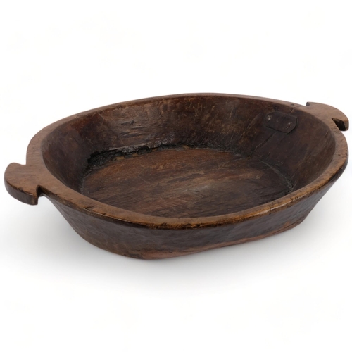 698 - A large hand carved polished wood dough or fruit bowl, 45cm diameter