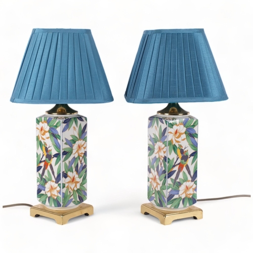 728 - A pair of cloisonne table lamps, with floral and tropical bird decoration, both with matching shades... 