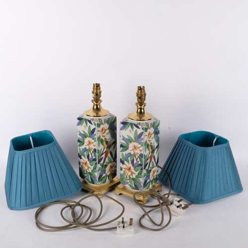 728 - A pair of cloisonne table lamps, with floral and tropical bird decoration, both with matching shades... 