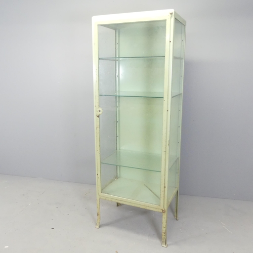 2666 - A vintage green enamelled metal medical cabinet, with three adjustable glass shelves. 61x170x41cm.