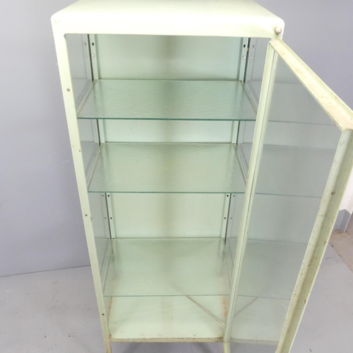 2666 - A vintage green enamelled metal medical cabinet, with three adjustable glass shelves. 61x170x41cm.