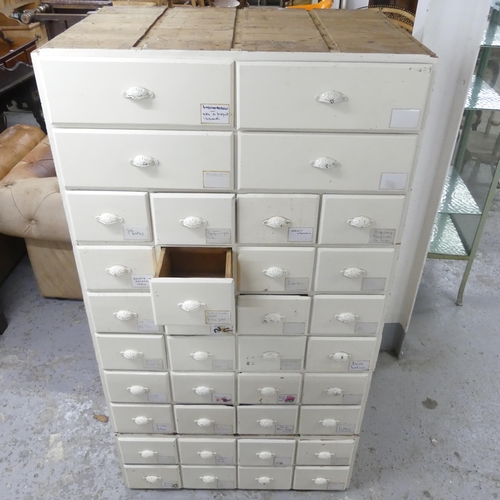 2668 - A painted pine two-section bank of 36 drawers 86x160x62cm.