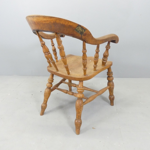 2677 - An antique elm-seated smoker's bow-arm desk chair.