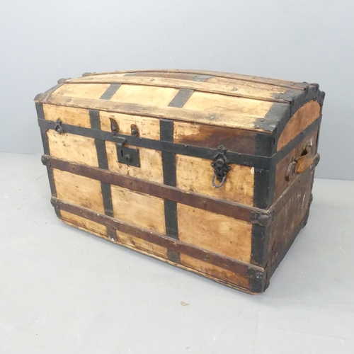 2681 - A 19th century pine dome top trunk, with metal and oak binding. 88x60x51cm.