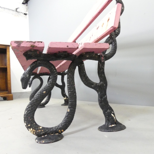 2690 - An antique painted slatted garden bench on cast iron frame, with serpent design. 122x78x56cm.