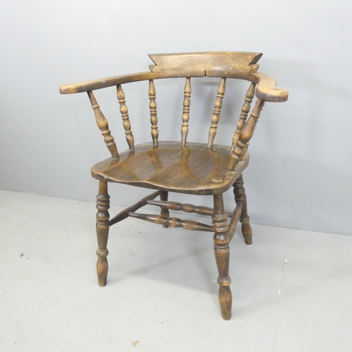 2698 - An antique elm-seated smoker's bow arm desk chair.