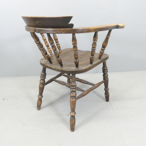 2698 - An antique elm-seated smoker's bow arm desk chair.