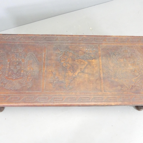 2708 - A leather covered mahogany rectangular coffee table, with tooled South American decoration. 129x42x5... 