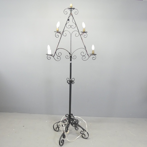 2720 - A painted wrought metal gothic candelabra converted to electric. Height 184cm.