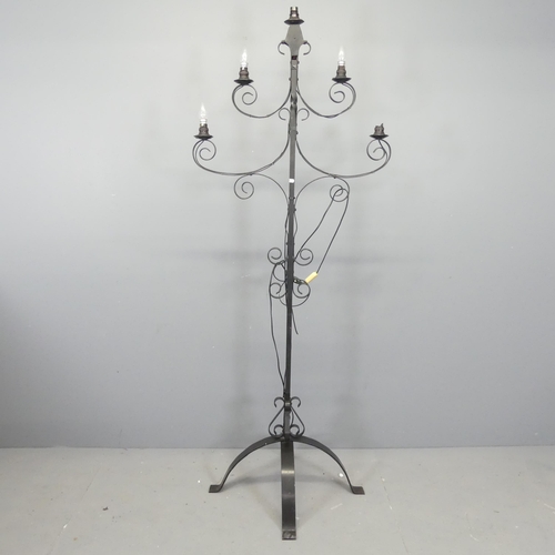 2722 - A painted wrought metal gothic candelabra converted to electric. Height 185cm.