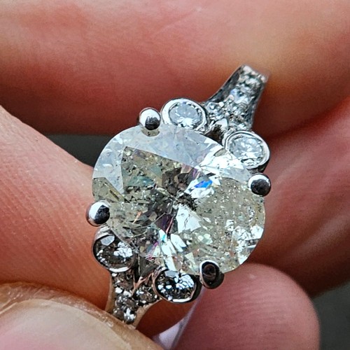 1155 - An impressive 14ct white gold fracture filled and laser drilled 4.35ct solitaire diamond ring, the c... 