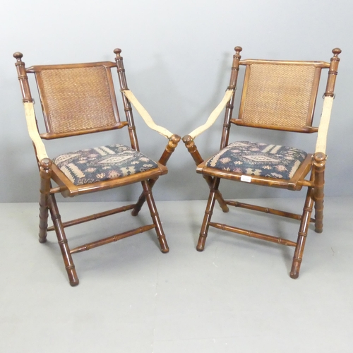 2729 - A pair of mahogany faux bamboo campaign style folding chairs with upholstered drop-in seats.