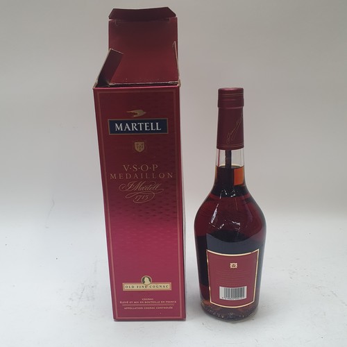 675 - Various bottles of spirits, including Remy Martin, and Martell Cognac