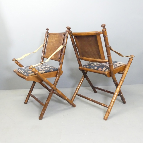 2729 - A pair of mahogany faux bamboo campaign style folding chairs with upholstered drop-in seats.