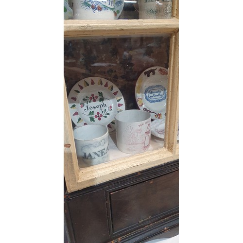 793 - An 18th century painted hanging cabinet, containing an amazing display of 19th century Staffordshire... 