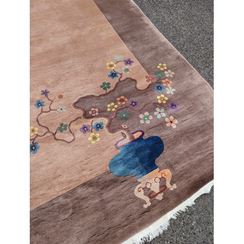 2727 - A large brown-ground Chinese style carpet. 410x320cm.