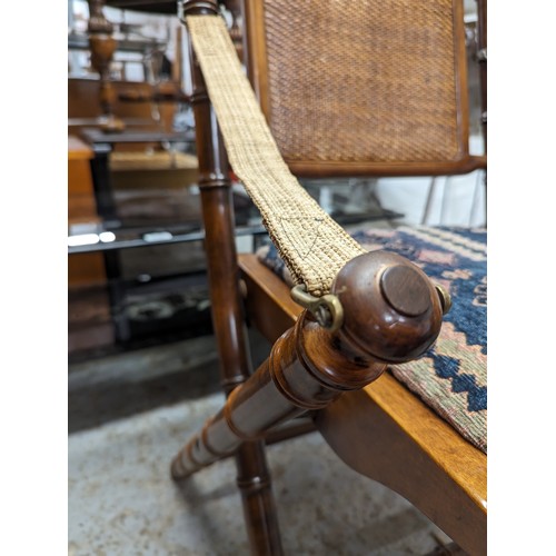 2729 - A pair of mahogany faux bamboo campaign style folding chairs with upholstered drop-in seats.