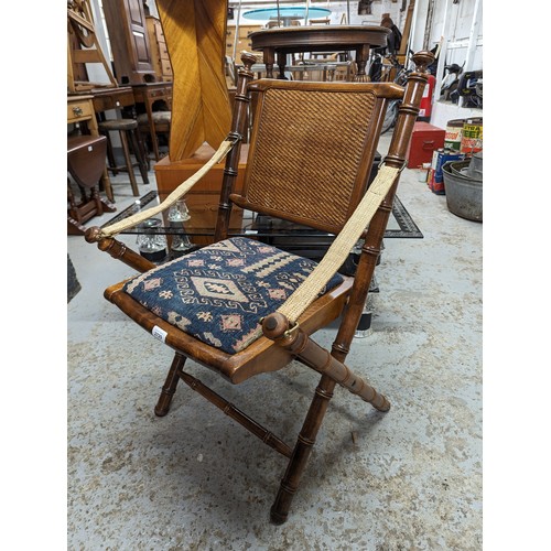 2729 - A pair of mahogany faux bamboo campaign style folding chairs with upholstered drop-in seats.