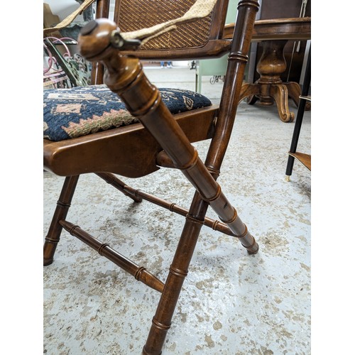 2729 - A pair of mahogany faux bamboo campaign style folding chairs with upholstered drop-in seats.