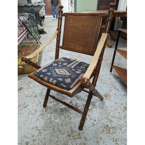 2729 - A pair of mahogany faux bamboo campaign style folding chairs with upholstered drop-in seats.