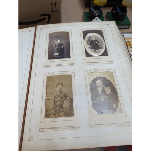 88 - A Victorian velvet covered photograph album, containing a collection of carte de visite and cabinet ... 