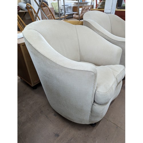 2040 - A pair of upholstered art deco design cloud back tubchairs in the manner of Epstein. Overall 88x86x9... 