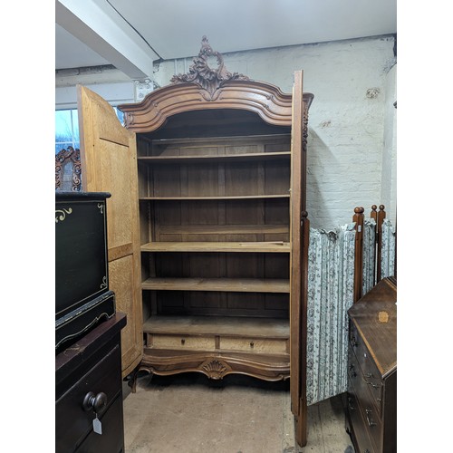 2167 - A French kingwood veneered arch-top armoire, with two mirror doors, shelf fitted interior and applie... 