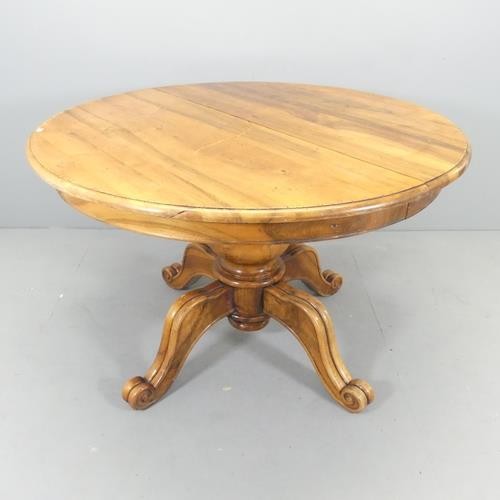 2737 - A French mahogany circular topped dining table, on turned central column with quadruple leg base. 12... 