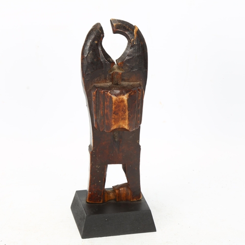 101 - A Baule, Ivory Coast weaving pulley, carved wood masked figure on wooden plinth, height 16cm