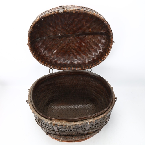 103 - An Indonesian hand-woven fishing basket with metal mounts, height 35cm