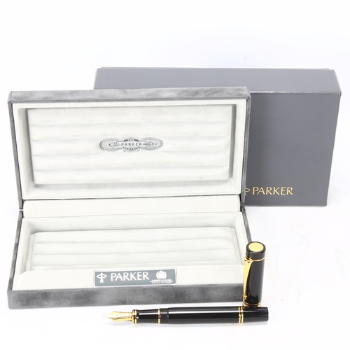 106 - A Parker Duofold Centennial fountain pen, with black lacquer and gilt metal body, 18ct gold (M) nib,... 