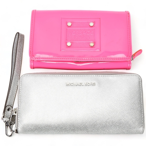 117 - Two designer purses - Michael Kors silvered leather purse and a Versace hot pink plastic purse with ... 