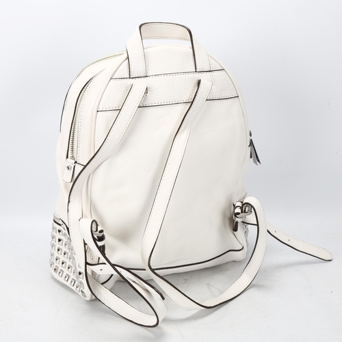 119 - A Michael Kors white leather back pack, with metal studded detail, tow main compartments and fitted ... 