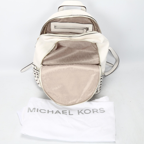 119 - A Michael Kors white leather back pack, with metal studded detail, tow main compartments and fitted ... 