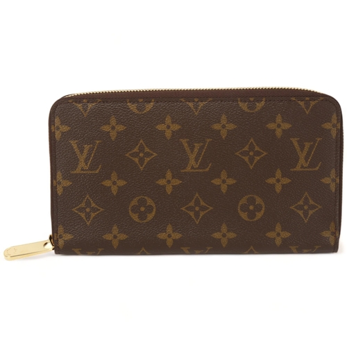 122 - **WITHDRAWN**A Louis Vuitton purse, logo textile cover and leather lining, 12 card holder slots and ... 