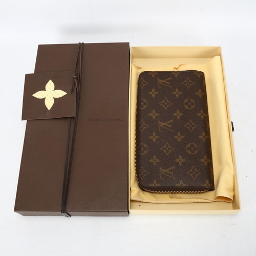 122 - **WITHDRAWN**A Louis Vuitton purse, logo textile cover and leather lining, 12 card holder slots and ... 