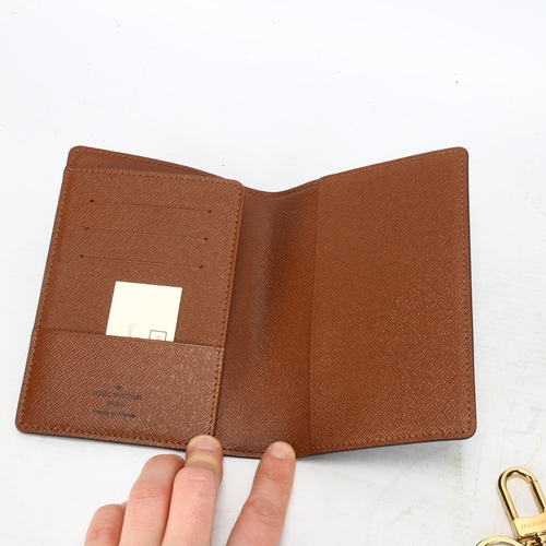 124 - **WITHDRAWN**A Louis Vuitton wallet, logo textile cover and leather lining, 3 card holder slots and ... 