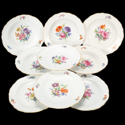 144 - A set of Meissen porcelain plates with painted floral centres and gilded edges (9)