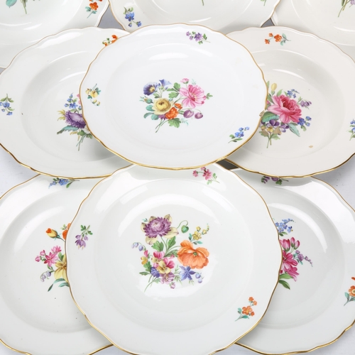 144 - A set of Meissen porcelain plates with painted floral centres and gilded edges (9)