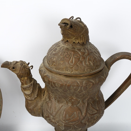 154 - A Tibetan copper ewer decorated with mythological beasts, height 38cm, and 2 copper dishes (3)