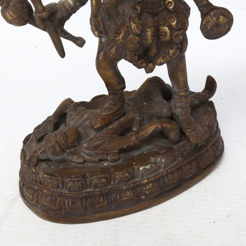 164 - A Indian bronze statue of Kali and Lord Shiva, height 23cm